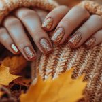 autumnal glitter nails knitted gloves amidst fallen leaves